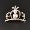 Detail of a sparkling alloy crown brooch with dual pearls and rhinestones on black - 2-Pearl Gold Crown