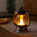 Close-up of vintage bronze LED lantern on sheet music with warm glowing festive lights - Brushed Silver