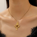 Vintage gold necklace featuring a cross pendant with brown tiger eye stone on model - Gold Winged Cross Necklace Style (WG-0255)