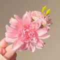 Handcrafted pink mesh flower hair clip with yellow buds on a warm background - Pink Rose Hair Clip