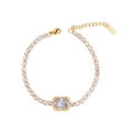 Macro detail of gold plated bracelet featuring a large square zircon centerpiece with extension chain - White (B2338-W)