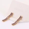 Detail of gold dangle earrings featuring purple rectangular zircons in a curved claw setting - Purple
