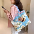 Light blue canvas tote bag featuring cute cartoon bee and daisy print on the front - Bee