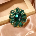 Vintage floral brooch in gold finish with emerald green crystals on champagne silk - Green
