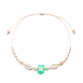 Detail of woven beach necklace featuring green frangipani flower and natural seashells - Green