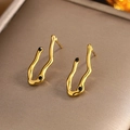 Vintage style gold earrings with wave pattern and black stone accents in jewelry box - Gold Irregular Wave Black Zircon (E-222)