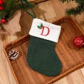 Green knit Christmas stocking with red embroidered letter D and holly berry detail - Letter D