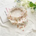 Detailed view of floral triangular headscarf with elastic band on an elegant plate - White Floral
