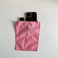 Portable pink nylon organizer pouch storing a smartphone and a car key for scale - Mini Pink