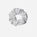 White satin silk scrunchie with elegant folds and elastic band on light grey background - White