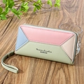 Women's long patchwork leather wallet with multi-card slots and wristlet strap on wood - Emerald Green