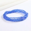 Close-up of blue handmade glass seed beads showing delicate texture and layered design - Blue