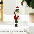 Detail of hanging nutcracker ornament with red uniform and candy cane for Christmas tree - Nutcracker Soldier with Candy Cane