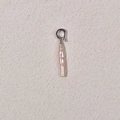 Baroque pearl earring with silver hook on textured beige background in macro view - White Small Bar Pearl + Silver Universal Buckle