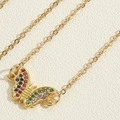 Macro detail of golden butterfly necklace with colorful zircon wings on a gold chain - Butterfly Necklace (XL2700)