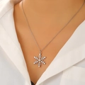 Silver snowflake necklace with clear rhinestones worn on a white shirt - 20 White K Style (DZ-914 Necklace)
