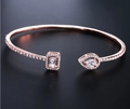 Detailed macro of rose gold open bracelet featuring pear and rectangle zircon stones - Rose Gold (White Stone)