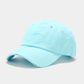 Detailed view of the distressed edges and frayed holes on light blue cotton baseball cap - Adjustable / Cyan
