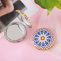 Macro shot of circular folding makeup mirrors with colorful geometric bohemian patterns - Style F