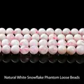 Natural white phantom quartz beads with snowflake inclusions on a black mirror surface - Natural White Snowflake Ghost / 6mm approx 60pcs