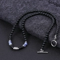 Macro shot of tiger eye bead necklace with blue-white beads and steel T-bar toggle clasp - Blue Spot Jasper