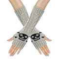 Close-up of beige knit fingerless gloves featuring a black skull pattern on the back - One Size / Light Gray
