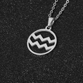 Polished silver Aquarius zodiac necklace with wavy symbol on a circular pendant - Aquarius / Steel