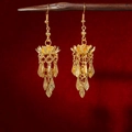 Detail of golden bohemian lotus earrings with layered fringe tassels and a vintage finish - E2439-3 Double Layer Lotus Tassel