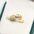 Macro detail of gold flower ring with colorful pear-cut zircons on white velvet - Multicolor Pear Shaped Gemstone Petal Style (金色7)