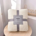 Folded cream flannel throw blanket with vertical ribbed texture and premium grey gift wrap - 70x100cm / Pearl White