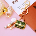 Detail of green crystal handbag keychain with white rose and luxury pearls on gold chain - Dark Green Pearl Handbag