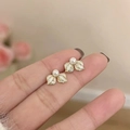 Elegant gold bow earrings with white pearls and tassels in a leaf motif design - Gold Pearl Leaf