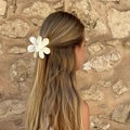 Cream-colored floral hair claw clip shown on a model for a natural hairstyling look - White