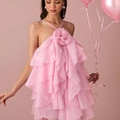 Detailed close-up of pink layered ruffles and 3D floral decoration on halter dress - Pink