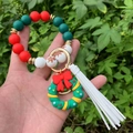 Detail of Christmas silicone bead keychain with green wreath charm and white tassel pendant - Style 7 (Green Wreath Gingerbread Man)