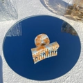 White and orange marble acetate hair claw clip with Amy Bear lettering on a mirror - Orange Mint