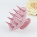 Close-up of pink silicone scalp massager brush with soft tapered bristles on light background - Simple Style / Light Purple
