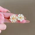 Elegant cream flower stud earrings with pearl texture petals and golden bead centers - Cream Shell Texture Flower