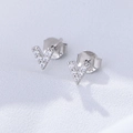 Macro shot of V-shaped S925 silver stud earrings with sparkling zircon inlay - 925 Silver / White