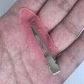 Pink leaf-shaped hair clip with gold glitter in resin held by hand for scale - Transparent Rose Red with Gold Glitter