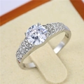 Macro shot of silver wedding ring with large round center stone and pave diamond accents - US 7 / Style 2 Silver