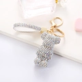 Detailed view of sparkling silver rhinestone bear keychain with a matching glittery hand strap - White AB Color