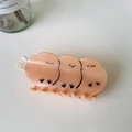Detailed view of an orange cartoon chick hair claw clip made of glossy resin material - Orange Tit Bird