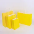 Set of four bright yellow paper shopping bags with white handles in various sizes - Bright Yellow; 15*8*21 (small Vertical Stroke)