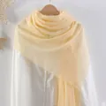 Pale yellow cotton linen scarf with frayed edges hanging on a white shirt display - Light Yellow