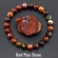 Macro view of Red Pine Stone beaded bracelet with natural mineral textures on grey background - Red Howlite