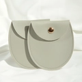 Two gray round-bottom PU leather jewelry pouches with gold snap buttons on white fabric - 8*8.5cm / Gray
