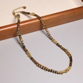 Necklace with brown square beads and golden irregular accents on a wooden display tray - XL0092 Brown Square Beads Gold Metal