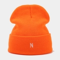 Detailed view of ribbed texture and white letter N embroidery on orange knit beanie - One Size / Orange Red