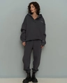 Detail of grey oversized hoodie set with white logo and high-waist joggers texture - Dark Gray